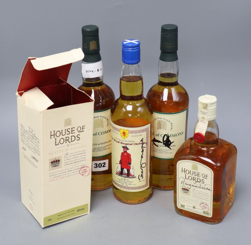 A bottle of House of Lords whisky signed by Margaret Thatcher and three other autographed bottles.